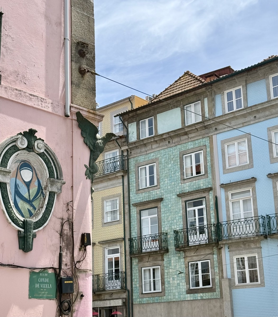 Colourful azulejo tiles on a Porto street facade, traditional Portuguese hand-painted ceramic tiles