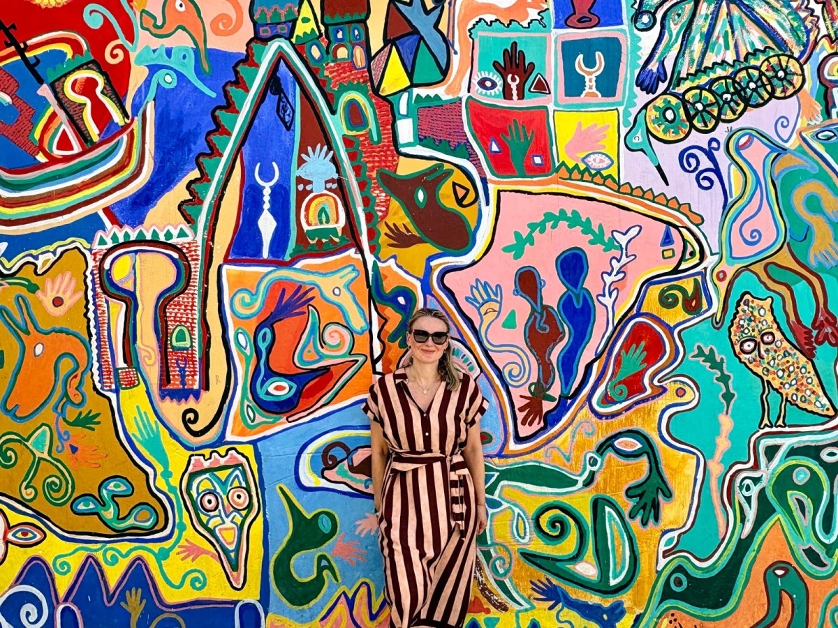 A traveller in a striped dress before a vibrant Asilah festival mural — cover image for a Tangier to Chefchaouen journey through northern Morocco